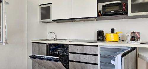 a kitchen with a sink and a stove top oven at Casa Guarnati Lake View Apartments in Malcesine