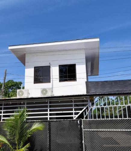 a white house on top of a fence at Casa La Frontera in Sixaola