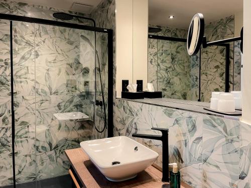 a bathroom with a sink and a shower at Altstadt-Hotel in Freiberg