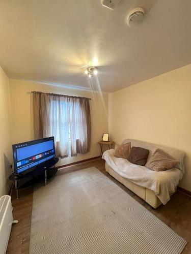 a living room with a bed and a flat screen tv at Apartment 6 in Drogheda
