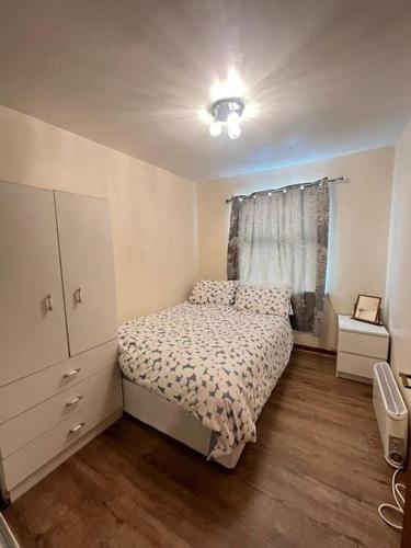 a small bedroom with a bed and a dresser at Apartment 6 in Drogheda