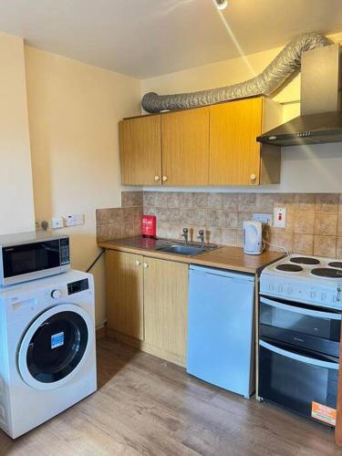 a kitchen with a washing machine and a washer at Apartment 6 in Drogheda
