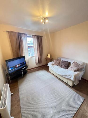 a living room with a bed and a flat screen tv at Apartment 6 in Drogheda