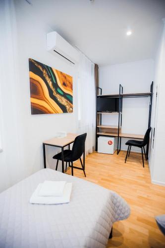 a room with a bed and a table and chairs at Staryi Krakiv in Lviv