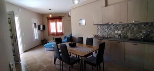 a kitchen and dining room with a table and chairs at Smailis apartment 1 in Koróni