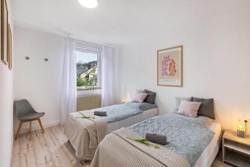 a bedroom with two beds and a window at Apartment Alb Glück 2 in Hechingen
