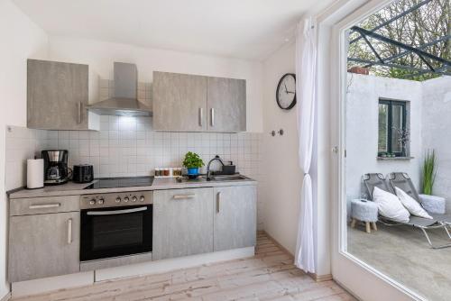 a kitchen with a stove top oven next to a window at Apartment Alb Glück 2 in Hechingen