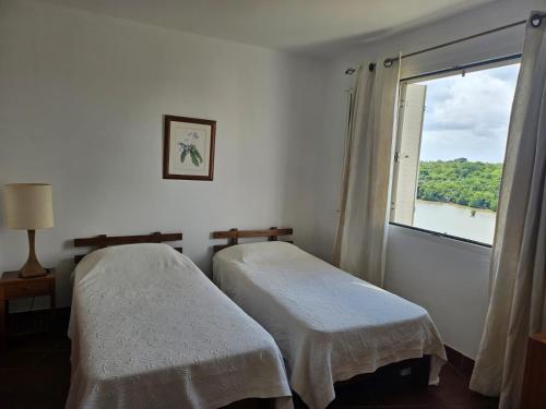 two beds in a room with a window at Casa in Terre Rouge