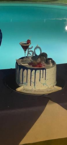 a birthday cake sitting on a plate on a table at Il Rustico in Pozzillo
