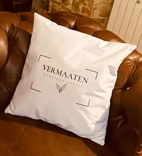 a white pillow sitting on a brown leather couch at Vermaaten Boutique Suites Ruby in Todi