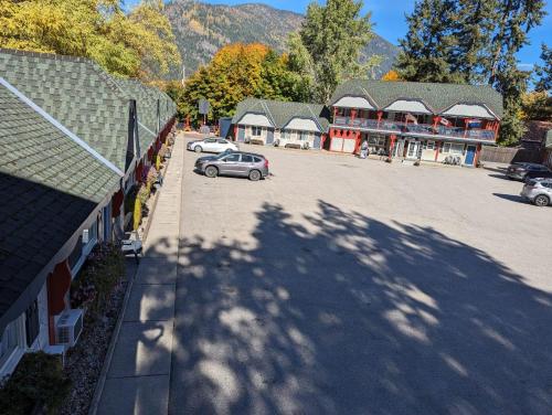 a car parked in a parking lot in front of a building at Alpine Inn & Suites in Nelson