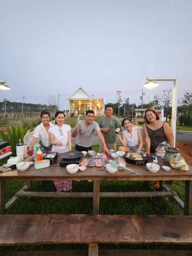 a group of people sitting around a picnic table at Maryland Khaoyai Annapolis Pool Villa in Ban Nong Song Hong