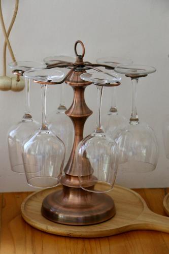 a group of wine glasses on a wooden table at Maryland Khaoyai Annapolis Pool Villa in Ban Nong Song Hong