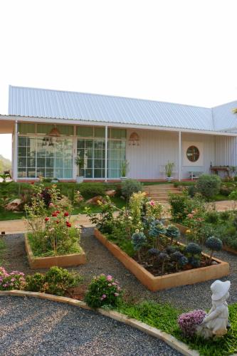a garden in front of a building with flowers at Maryland Khaoyai Annapolis Pool Villa in Ban Nong Song Hong