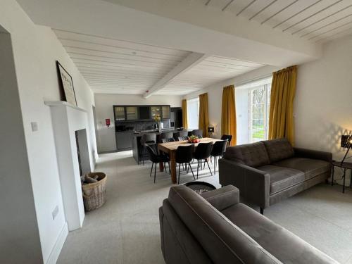 a living room with a couch and a table at Glebe House in Sion Mills