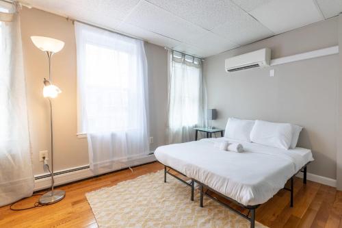 a bedroom with a bed with a stuffed animal on it at Central 3 Bed 1 Bath in Historic Building in Boston