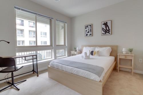 a bedroom with a bed and a desk and windows at Quiet Apartment with Amazing Amenities @Alexandria in Alexandria