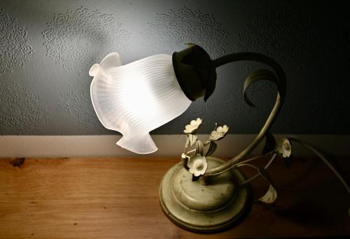 a lamp in a vase on a table at Studio Apartman UNA -self check in,free parking in Karlovac