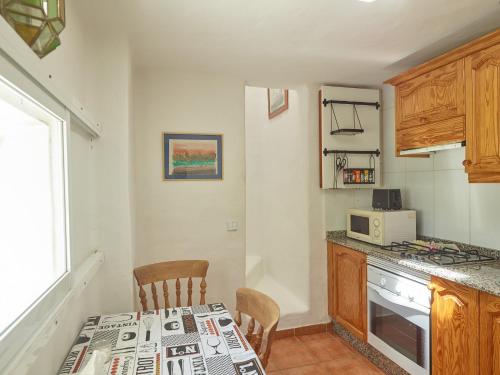 a kitchen with a table and a stove top oven at Finca La Calerita D in Uga