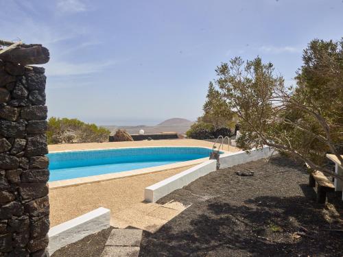 a swimming pool in front of a house at Finca La Calerita D in Uga