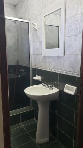 bagno con lavandino e doccia con specchio di Hotel Nuevo Real a Formosa