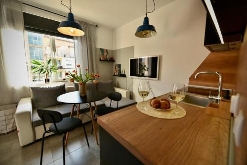 a kitchen and living room with a sink and a table at Cozy apartment Sunny Beach in Sunny Beach