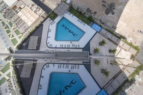 an overhead view of two swimming pools at Damac Tower Jeddah apartment in Jeddah