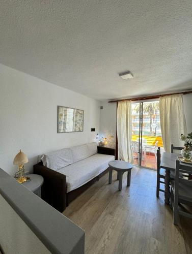 a living room with a bed and a table at il centro delle vacanze in Playa de las Americas