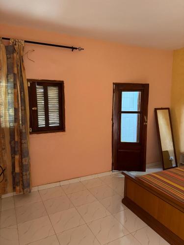a bedroom with a bed and a window at keur manga in Somone