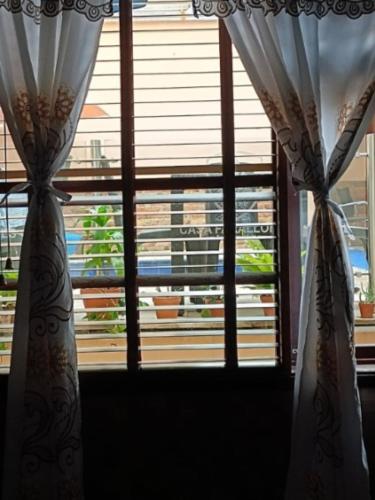 two curtains in front of a window with a view at HBCF Hotel Boutique Casa Farallones de Santiago de Cali in Cali