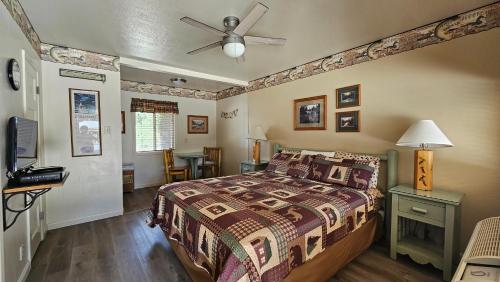 a bedroom with a bed and a ceiling fan at Sequoia Lodge in Kernville