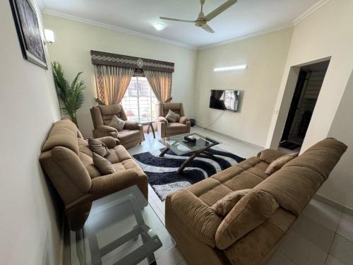 a living room with a couch and a table at Holidazzle Villa in Karachi