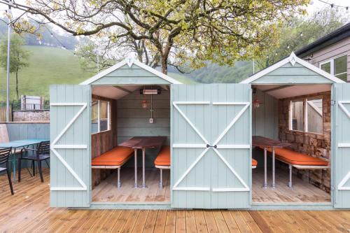 a shed with an open door on a deck at Dartmoor Halfway Campsite in Newton Abbot