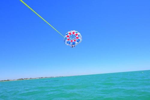 a kite flying in the sky over the ocean at Near Beach/kayaks/HtdPool/Tiki/BBQ/Gameroom in Pompano Beach