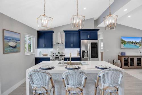a kitchen with blue cabinets and a large white island at Near Beach/kayaks/HtdPool/Tiki/BBQ/Gameroom in Pompano Beach