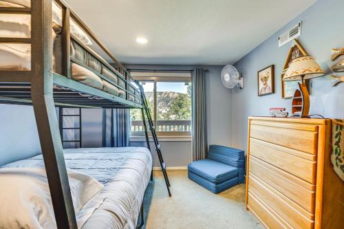 a bedroom with a bunk bed and a chair at Cozy Estes Park Condo with Balcony and Fireplace! in Estes Park
