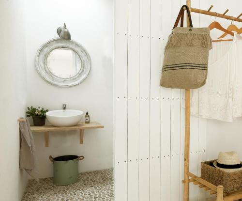 a bathroom with a sink and a mirror at Formentera Mind Yoga & Fit in Playa Migjorn