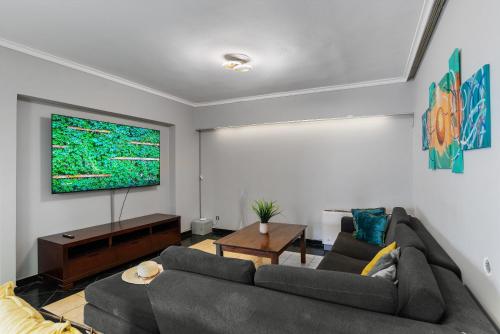 a living room with two couches and a flat screen tv at SeaviewHeaven - Private pool - Overlooking Chania in Chania Town