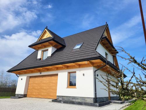 a house with a gambrel roof on top of it at Chochołowska Przystań in Chochołów