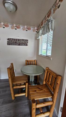 a dining room with a table and two chairs at Sequoia Lodge in Kernville