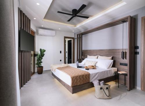 a bedroom with a bed with a ceiling fan at Alcyone Studios and Apartments in Heraklio Town