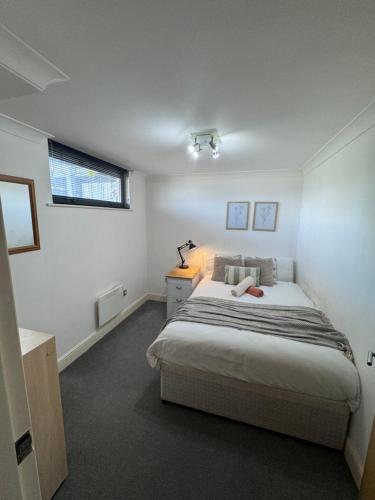 a bedroom with a large bed and a window at Luxury Rooms just off broad St Walking distance to city centre in Birmingham
