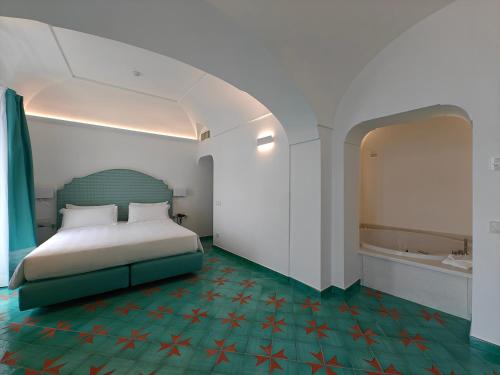 a bedroom with a bed and a bath tub in it at Hotel Residence in Amalfi
