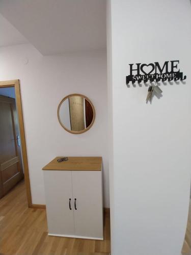 a bathroom with a mirror and a white cabinet at Su3ño Cántabro apto en Unquera in Unquera