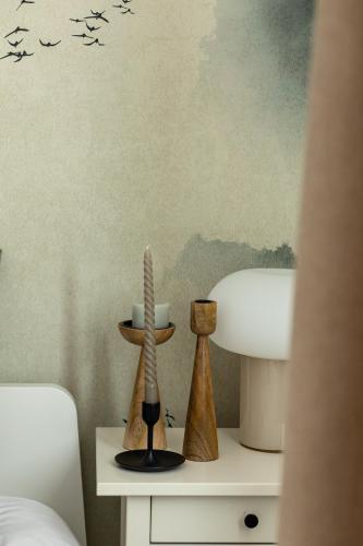 a bedroom with a table with birds on the wall at TS Hello City Apartment in Szczecin
