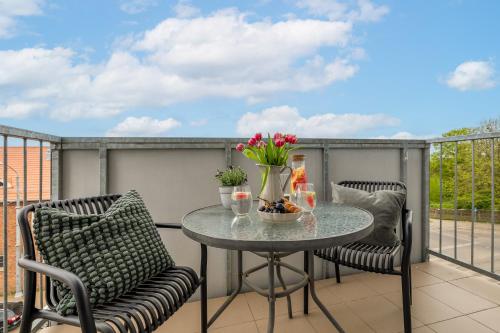 a balcony with a table and two chairs at TS Hello City Apartment in Szczecin