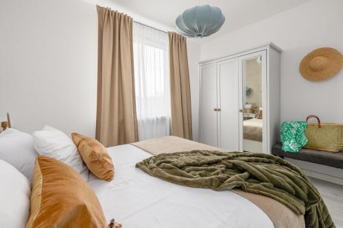 a bedroom with a bed with a blanket on it at TS Hello City Apartment in Szczecin