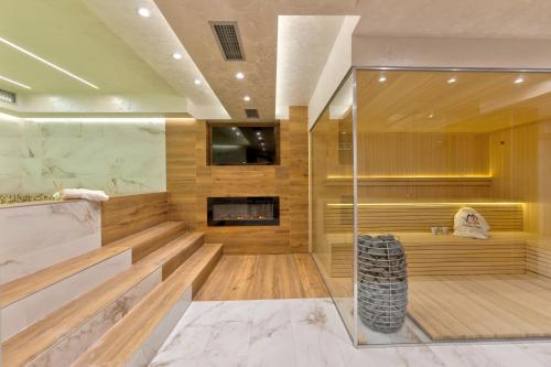 a large bathroom with a fireplace and a tv at Apartman Lux M&B 2 in Zlatibor