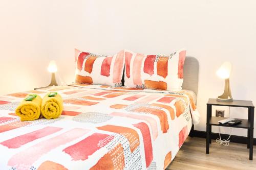 a bedroom with a bed with two yellow towels on it at Central Old Town Oasis - Ap 10 in Bucharest