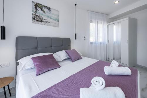 a bedroom with a large bed with towels on it at Sea Star Apartment in Cavtat